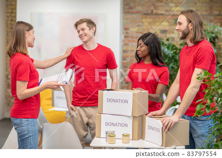 A group of young volunteers at work in a distribution point A group of young volunteers at work in a distribution point 83797554