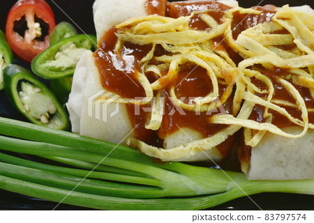 fresh Chinese spring roll made from flour wrapped tofu and pork with bean sprout dressing sweet red gravy sauce on plate 83797574