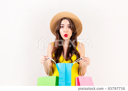 Young beautiful model with lots of shopping bags in hands. 83797738