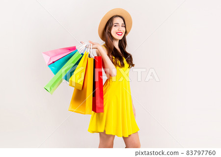 Young beautiful model with lots of shopping bags in hands. 83797760