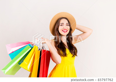 Young beautiful model with lots of shopping bags in hands. 83797762