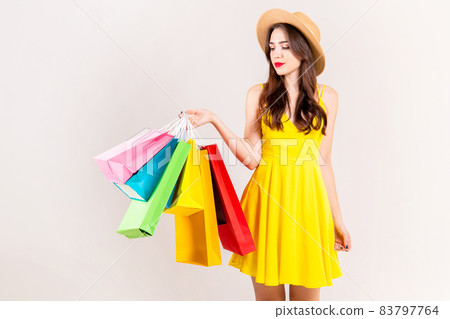 Young beautiful model with lots of shopping bags in hands. 83797764
