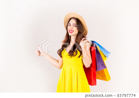 Young beautiful model with lots of shopping bags in hands. 83797774