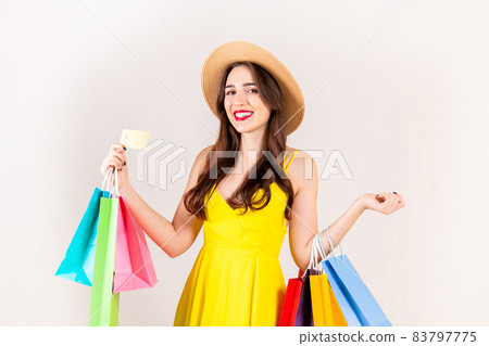Young beautiful model with lots of shopping bags in hands. 83797775