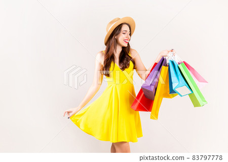 Young beautiful model with lots of shopping bags in hands. 83797778