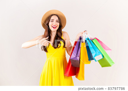 Young beautiful model with lots of shopping bags in hands. 83797786
