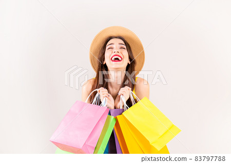 Young beautiful model with lots of shopping bags in hands. 83797788