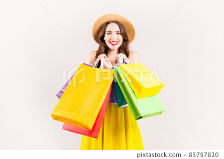 Young beautiful model with lots of shopping bags in hands. 83797810