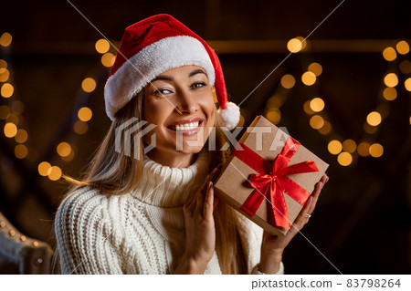 Happy Woman Holding Christmas Present At Home 83798264
