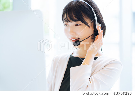Female operator working at a call center 83798286
