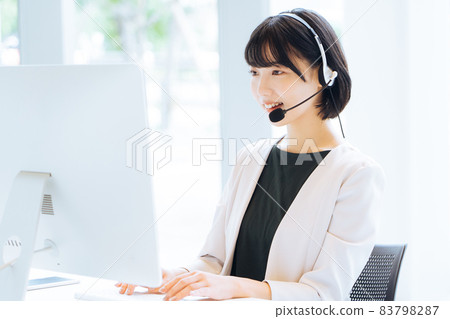 Female operator working at a call center 83798287