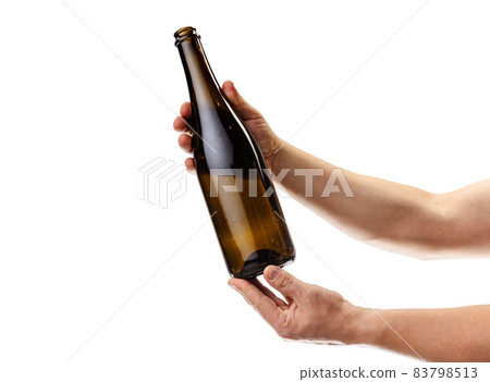 Cropped image of male hand holding bottle of white wine isolated over white background Cropped image of male hand holding bottle of white wine isolated over white background 83798513