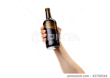 Cropped image of male hand holding bottle of strong alcohol drink isolated over white background Cropped image of male hand holding bottle of strong alcohol drink isolated over white background 83798568