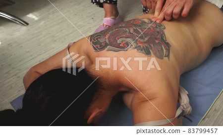 Top view. Handmade sensual massage on female nack on floor. Top view. Handmade sensual massage on female nack on floor. 83799457