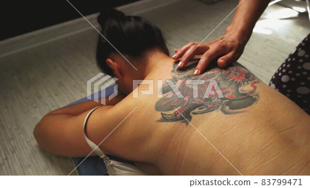 Top view. Handmade sensual massage on female nack on floor. Top view. Handmade sensual massage on female nack on floor. 83799471