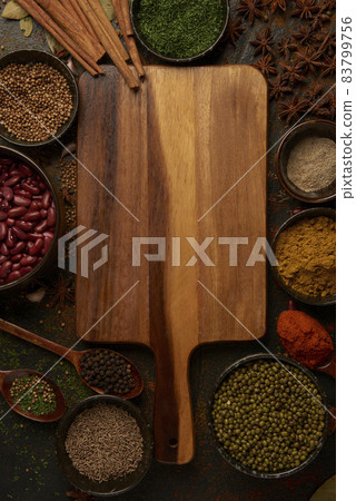 spices concept numerous types of spices power and pieces being sprinkled on the black table with other devices 83799756