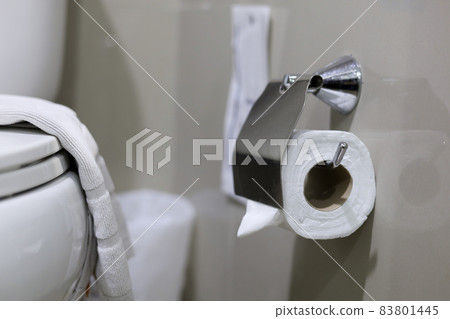 Clean toilet paper in the bathroom. Being folded and being used for the hotel guests Clean toilet paper in the bathroom. Being folded and being used for the hotel guests 83801445