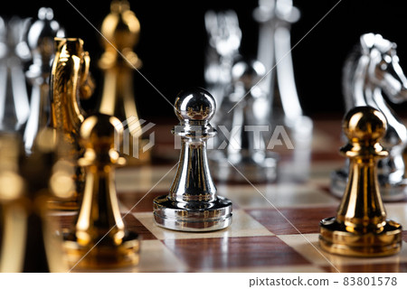 Gold and silver chess figures placed on chessboard 83801578