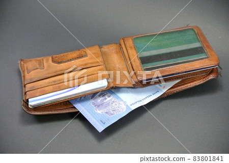 RM1 notes and a old wallet isolated on white background 83801841