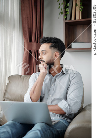 Pensive Man with Laptop 83802309