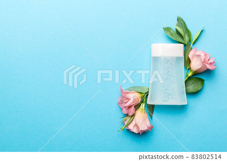 Composition with cosmetic products and beautiful roses on color background. Copy space, flat lay Composition with cosmetic products and beautiful roses on color background. Copy space, flat lay 83802514