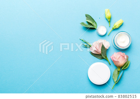 Composition with cosmetic products and beautiful roses on color background. Copy space, flat lay 83802515