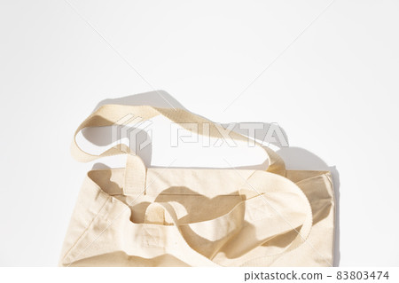 Eco-friendly cotton reusable bag on white background, flat lay, eco shopping Eco-friendly cotton reusable bag on white background, flat lay, eco shopping 83803474