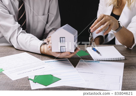 realtor giving keys new owner. High quality beautiful photo concept 83804621