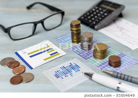 reading glasses piles coins high view. High quality beautiful photo concept reading glasses piles coins high view. High quality beautiful photo concept 83804649