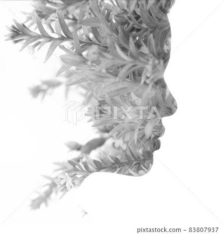 A black and white profile portrait of a woman combined with twigs in a double exposure technique A black and white profile portrait of a woman combined with twigs in a double exposure technique 83807937