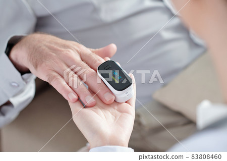Doctor Checking Oxygen Saturation Doctor Checking Oxygen Saturation 83808460