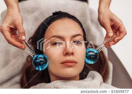 The woman is massaged face and body. The woman is massaged face and body. 83809877