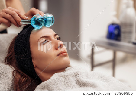 The woman is massaged face and body. The woman is massaged face and body. 83809890