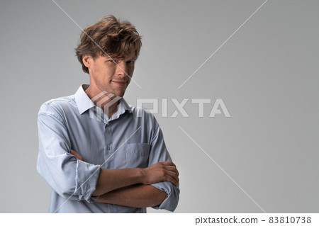 Positive man looks confidently with his arms crossed 83810738