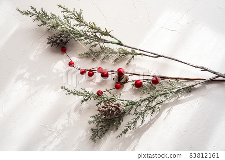 Simple Christmas interior wreath red fruit pine cone white background Simple Christmas interior wreath red fruit pine cone white background 83812161