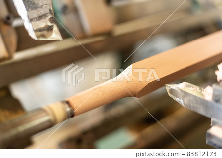 Wooden baluster lathe, unfocused background, shaped. Carpentry Wooden baluster lathe, unfocused background, shaped. Carpentry 83812173