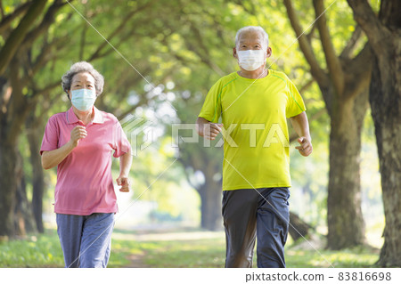 Asian Senior couple in face mask and jogging park Asian Senior couple in face mask and jogging park 83816698