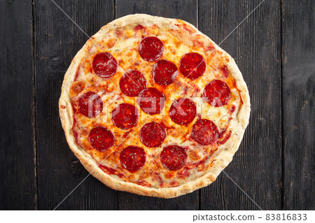 Top view on pepeproni pizza on wooden background 83816833