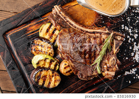Grilled beef steak with vegetables and sauce Grilled beef steak with vegetables and sauce 83816930