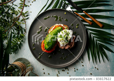 Avocado sandwich with roast beef and poached egg Avocado sandwich with roast beef and poached egg 83817622
