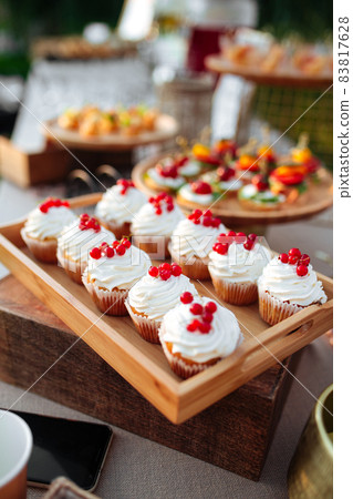 Closeup on banquet frosted cupcaked with berries Closeup on banquet frosted cupcaked with berries 83817628