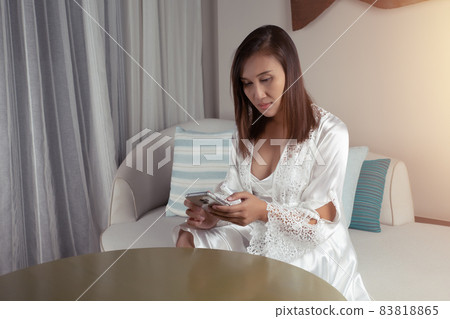 Woman looking at smartphone. 83818865