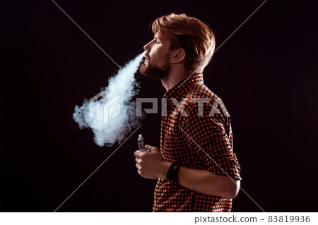 young man smoking electronic cigarette young man smoking electronic cigarette 83819936