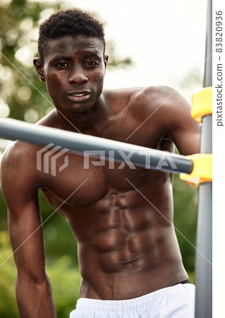 African man smiling after workout. He is in a park. 83820936