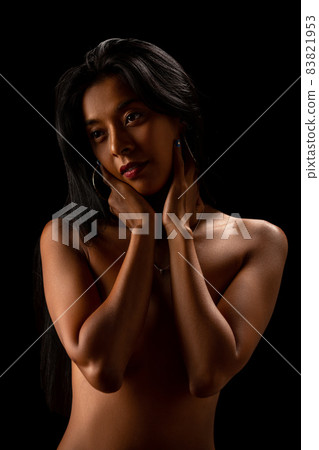 Asian nude sexy girl posing in studio. Low key Asian nude sexy girl posing in studio. Low key 83821953