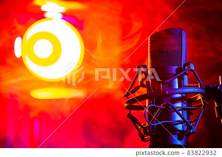 Professional microphone in red smoke on a black background. Professional microphone in red smoke on a black background. 83822932