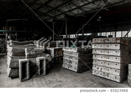 Cast iron tubing reinforced concrete cast products for lining distillation tunnels and underground structures are stored in the warehouse of the industrial plant Cast iron tubing reinforced concrete cast products for lining distillation tunnels and underground structures are stored in the warehouse of the industrial plant 83823468