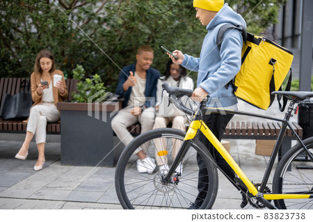Courier walking with bicycle and business people Courier walking with bicycle and business people 83823738