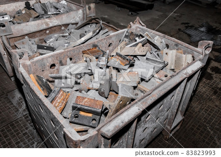 Iron parts of the workpiece for laying railway tracks metal structures in a heap at an industrial plant 83823993