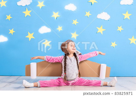 Girl pilot playing with toy jet pack at home. Success and leader concept 83825971